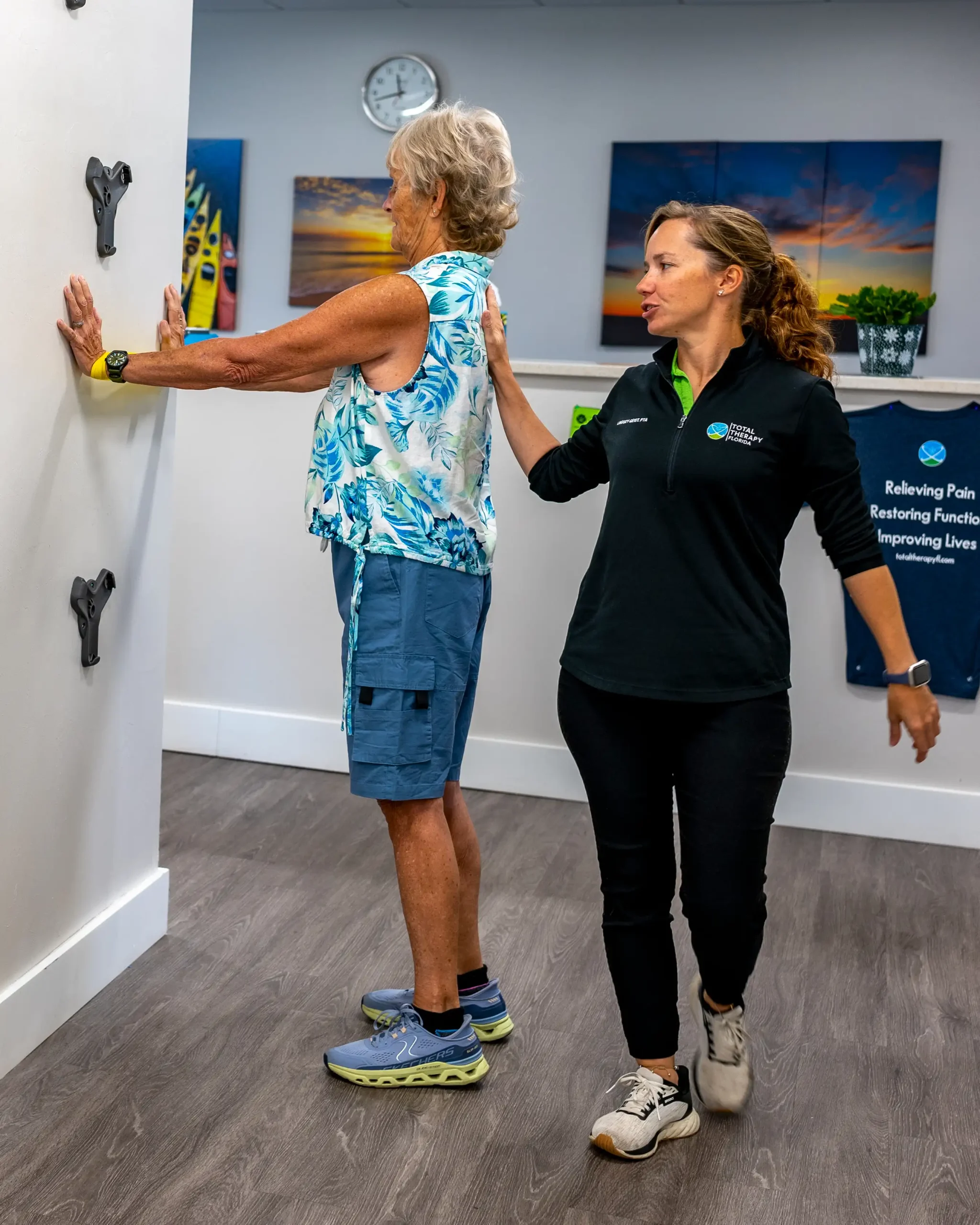 A Physical Therapy Assistant (PTA) assists a patient at Total Therapy Florida.