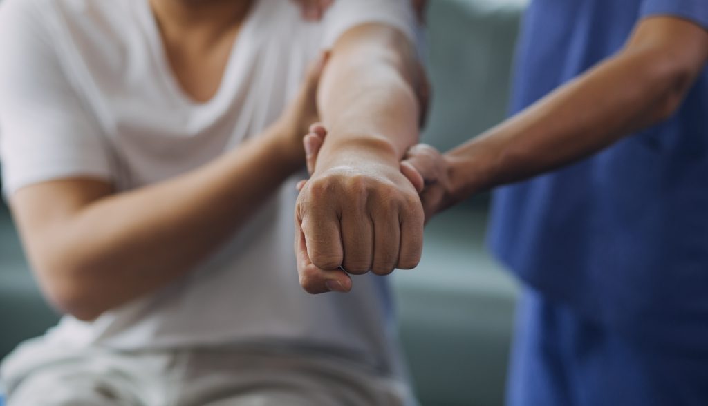 working on arm with therapist